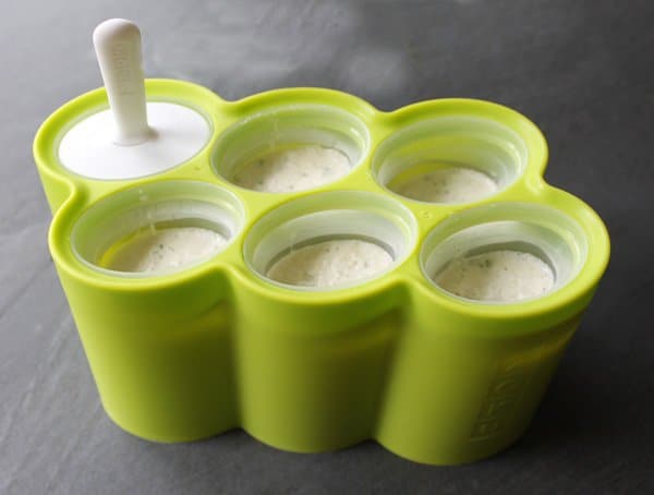 popsicle mold with coconut pops mixture ready to be put in the freezer.