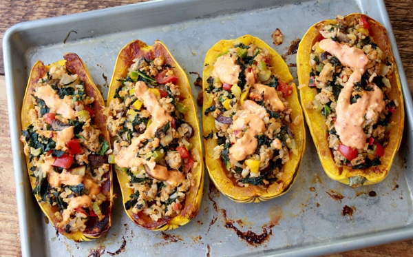 stuffed delicata squash delicata squash stuffed with turkey and brown rice on top of a baking tray
