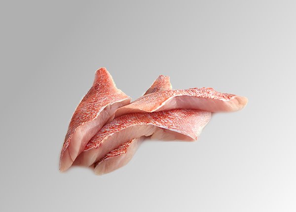 Gulf of Maine Redfish Fresh filets of Gulf of Maine Redfish piled on top of each other on a grey-white surface.