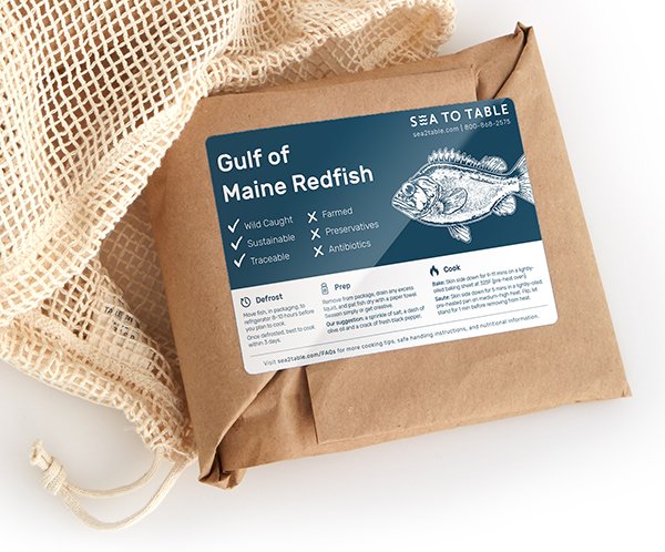 Sea to Table Redfish Gulf of Maine redfish wrapped in brown paper with a label ready for shipping and netted bag on the side.
