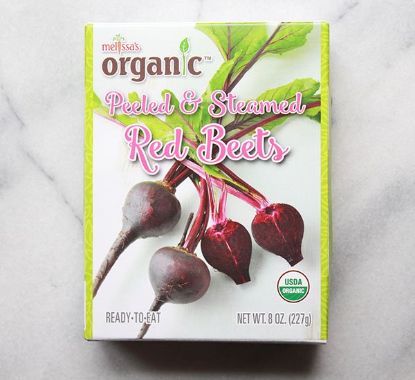 steamed red beets a boxed package of organic red beets on top of a marble surface