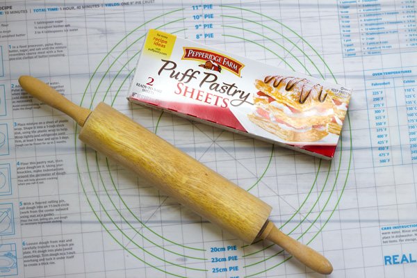 puff pastry A box of Pepperidge Farms puff pastry sheets and a wooden rolling pin on top of a baking mat.
