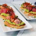 sushi grade tuna and salmon on avocado toast