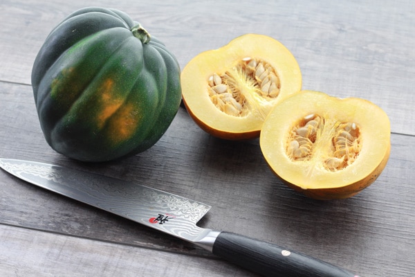 acorn squash acorn squash sliced in half with knife.