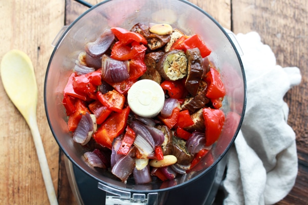 roasted eggplant, red bell peppers, onions, and garlic in food processor.