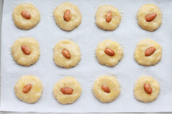 Chinese almond cookies before baking uncooked Chinese almond cookies on baking sheet ready to be put in the oven.