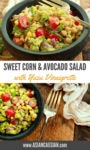 a vibrant corn and avocado salad in a black wooden bowl with a large silver fork