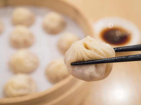 Closeup of Xiao Long Bao with chopsticks, Steamed Pork Dumplings, Taiwan food