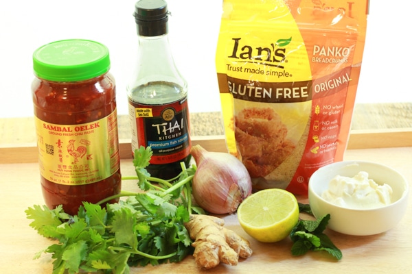 ingredients on a wooden board for making wild salmon burgers