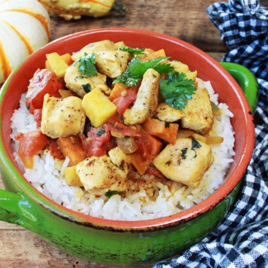 chunks of turkey in a green bowl atop white rice