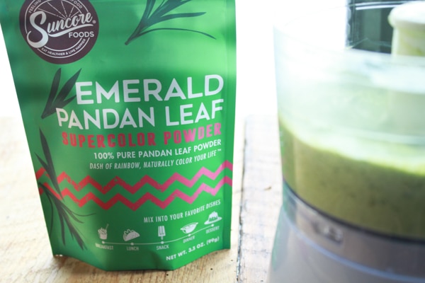 a package of pandan leaf supercolor powder on a wooden board with a food processor on the side