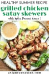 Tender satay chicken pieces cooked on wooden skewers on a white plate with a side of peanut sauce and fresh lime wedges