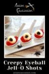 lychee eyeballs on top of red jello inside small white serving spoons