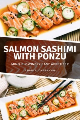 Slices of fresh sashimi salmon on a white platter with sliced cucumbers on top and sprinkles of black sesame seeds, with black chopsticks and a small white bowl of green wasabi on the side.