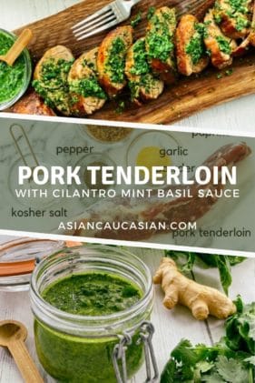 Thick slices of pork tenderloin on a rustic wooden board topped with a vibrant green cilantro, mint, basil sauce and a small bowl of sauce and a fork and herb sauce on the side.