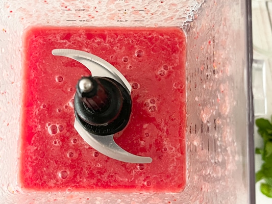 Watermelon strawberry slush cocktail in a blender