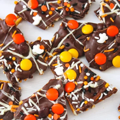 chocolate halloween bark made with pretzels, reece's pieces, and sprinkles