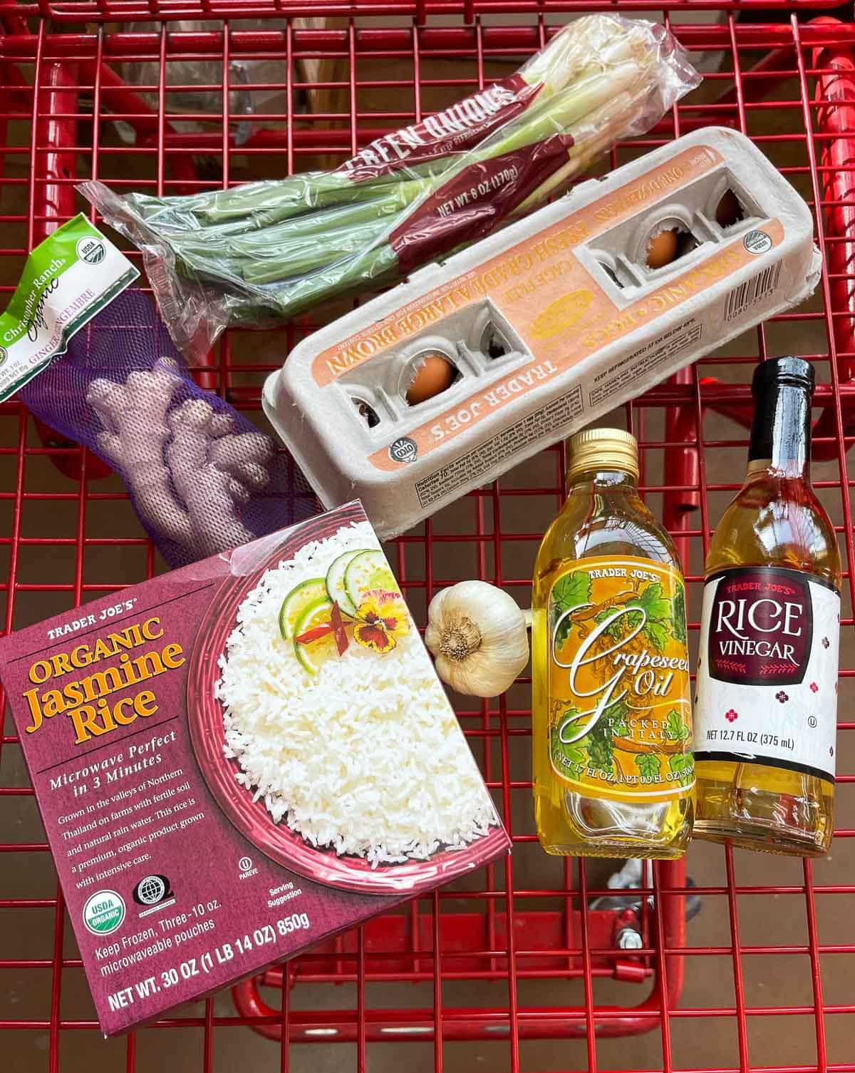 Trader Joe's ingredients for making crispy rice with ginger and scallions in a Trader Joe's red basket.