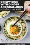 Crispy rice with ginger and scallions in a bowl topped with a runny fried egg with a pair of brown chopsticks, and a linen napkin on the side.