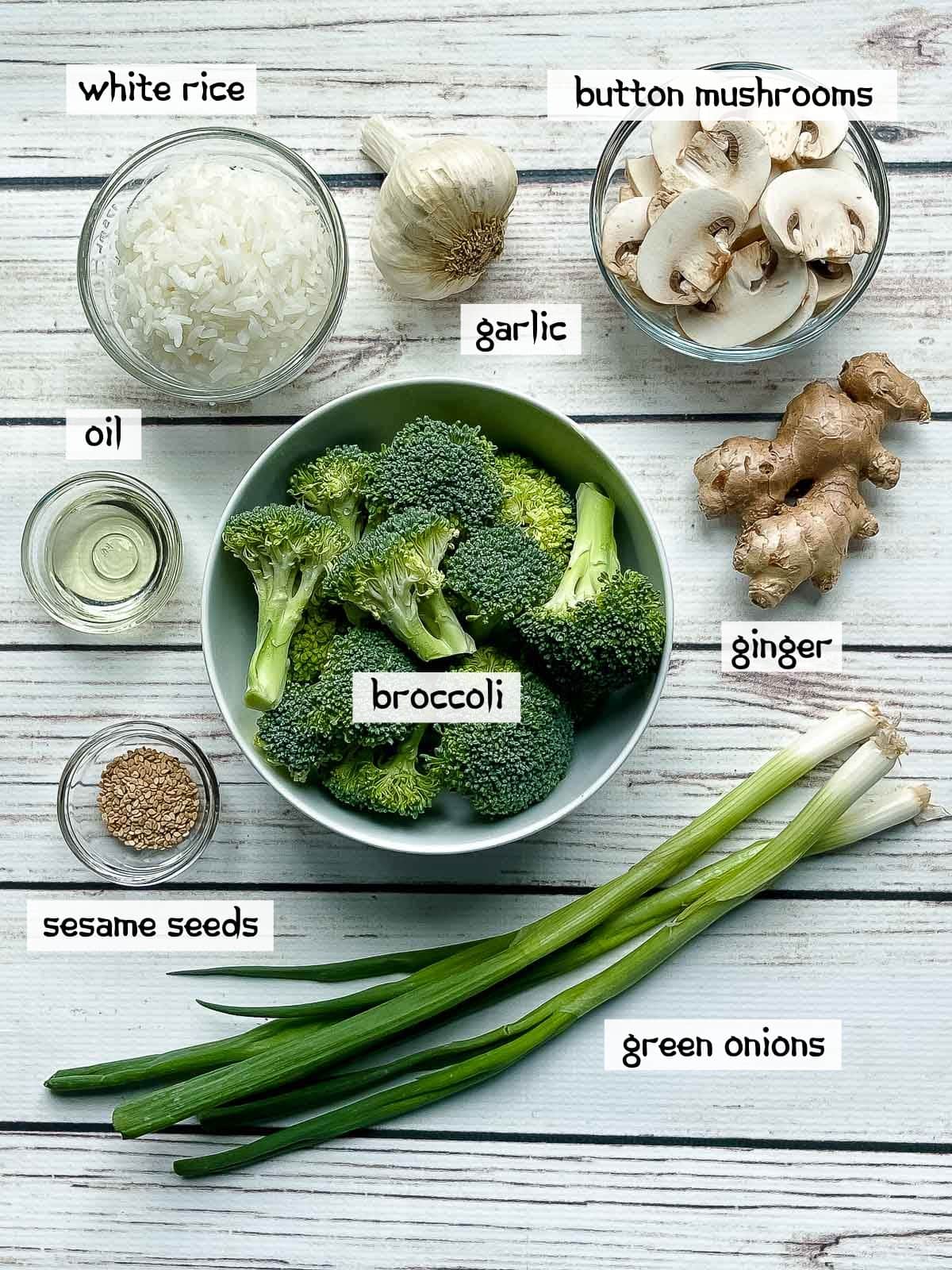 Labeled ingredients on a white board for making beef and broccoli stir fry.