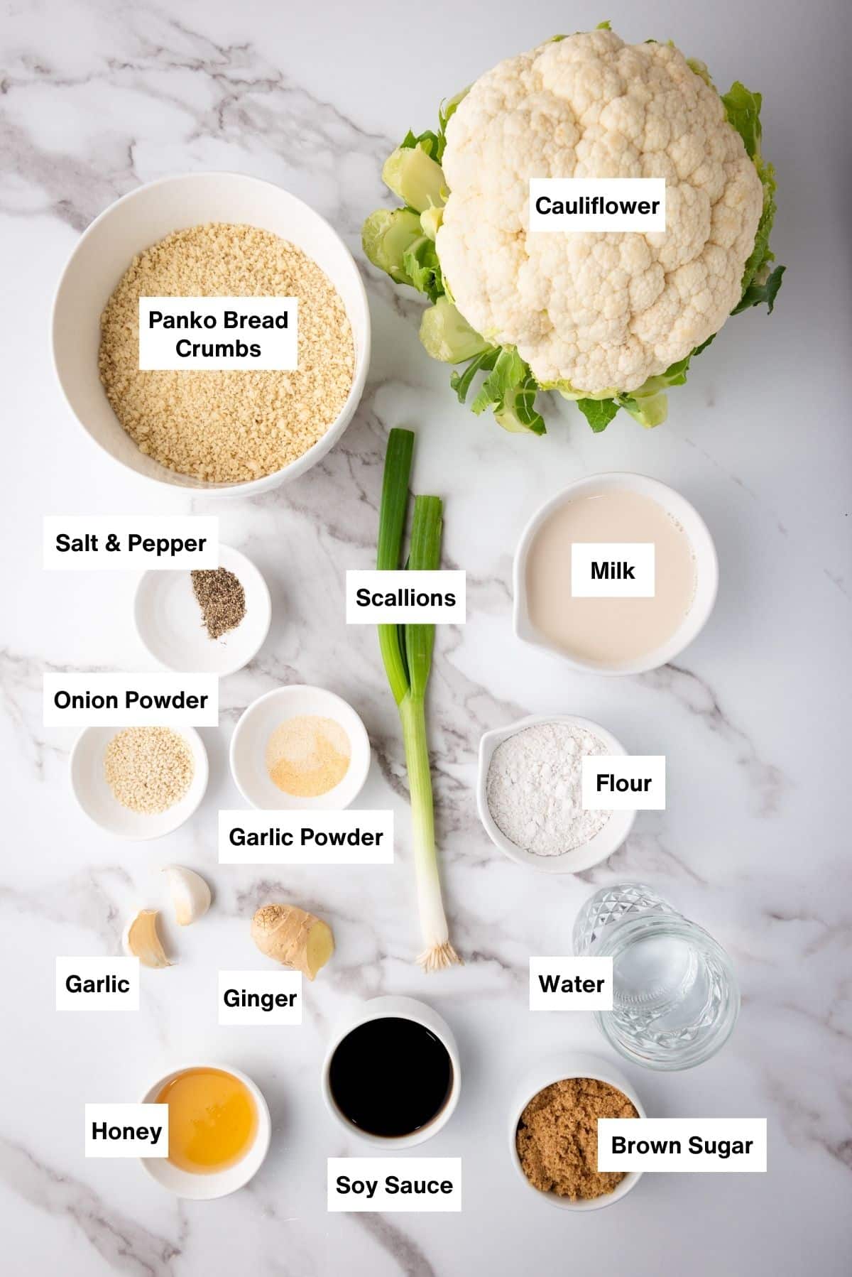 Labeled ingredients on a marble surface for making Air Fryer Teriyaki Cauliflower Wings.