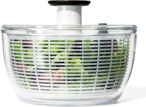 A large OXO Good Grips salad spinner on a white background.