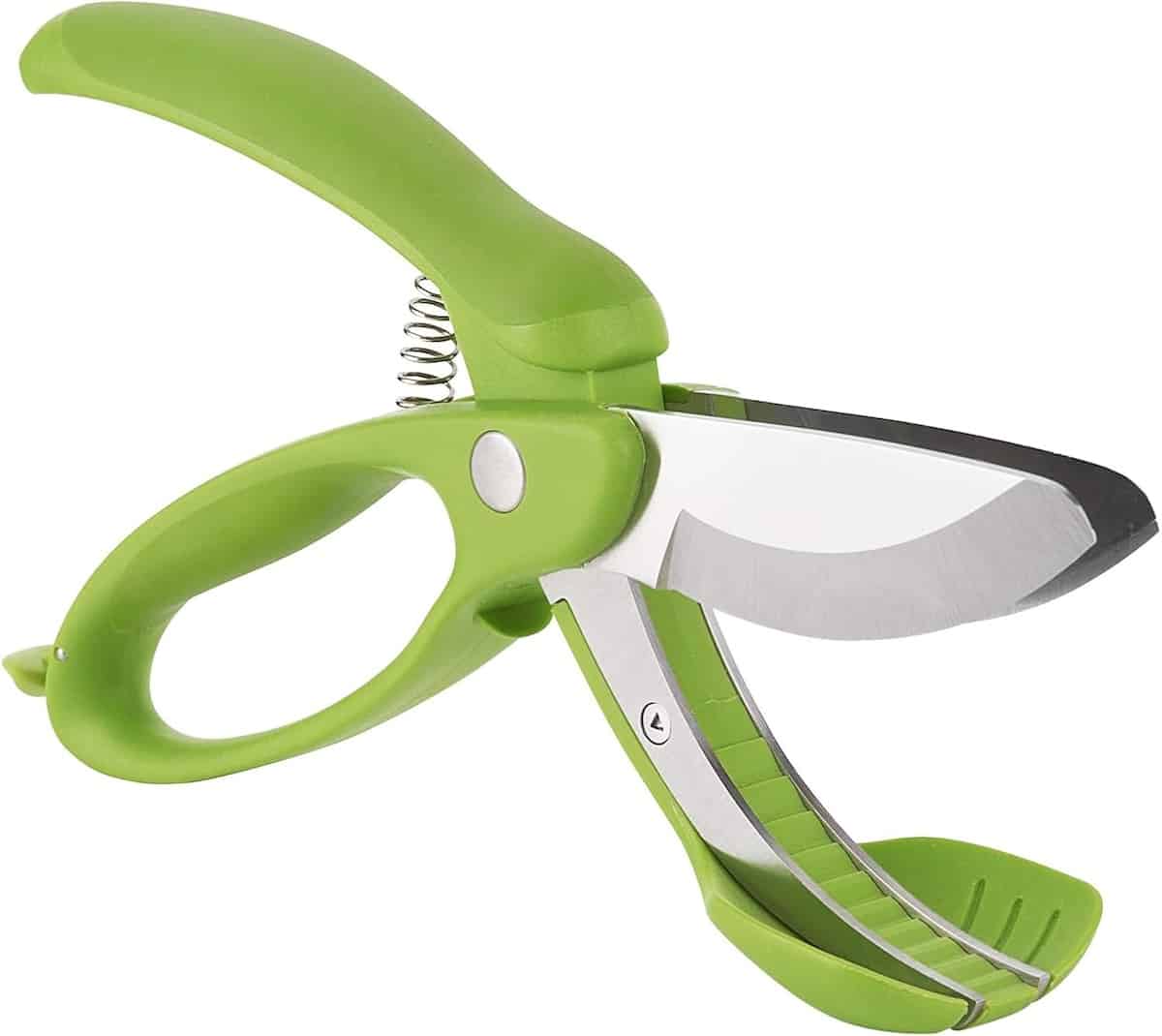 Green vegetable chopping scissors on a white background.
